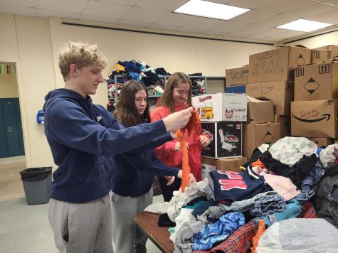Students sort clothes in KIND closet in preparation for Saturdays big open house. 